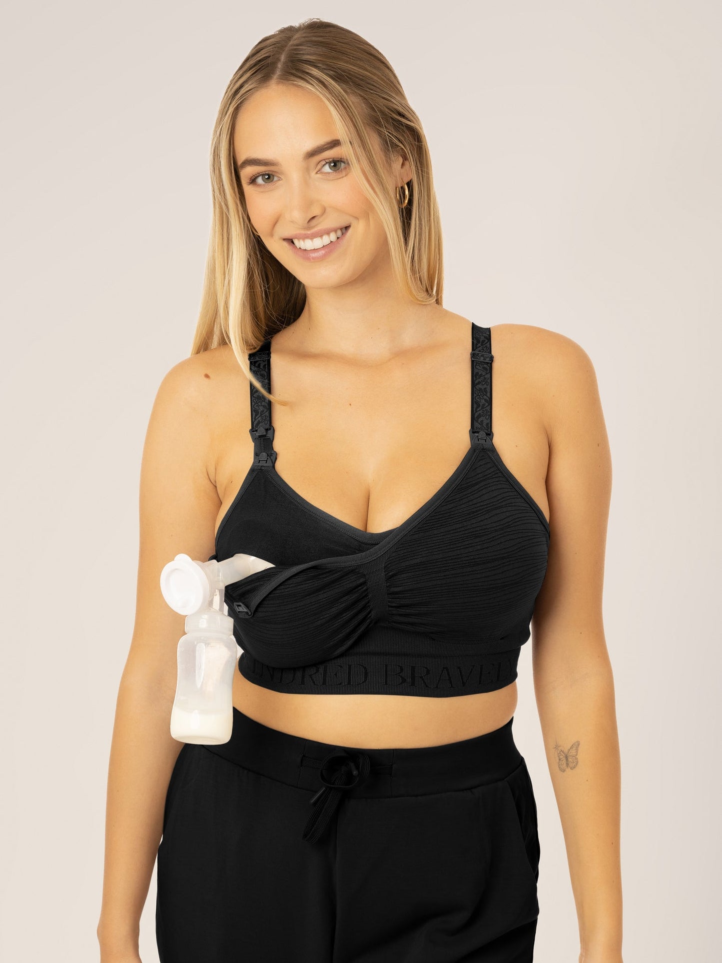 Busty model wearing the Sublime® Hands-Free Pumping & Nursing Bra in Black